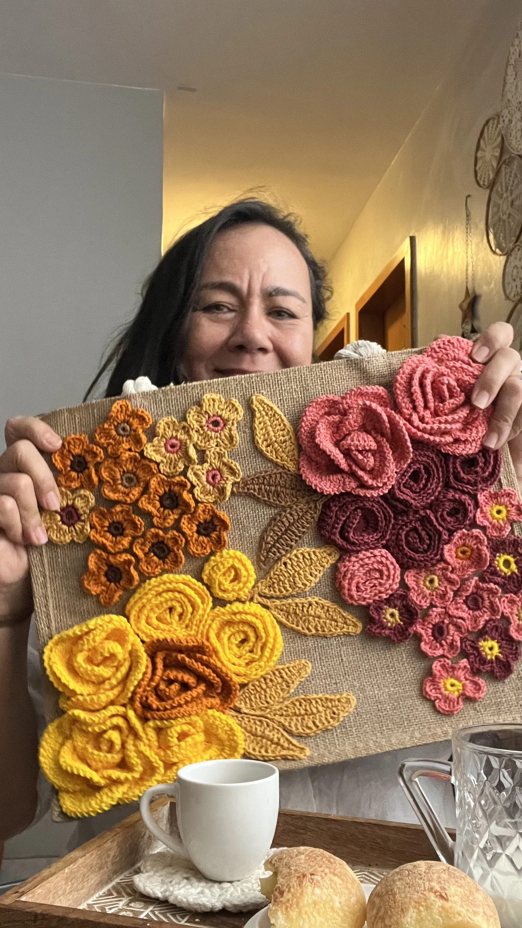 Detalhe das flores de crochê da bolsa, com foco na textura artesanal